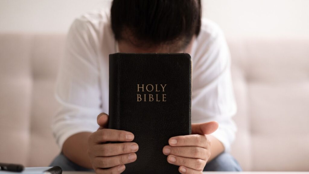 Christian woman with faith and hope, raises her hand in worship to pray to God and Jesus Christ, embodying her religion. woman, hand, faith, pray, worship, jesus