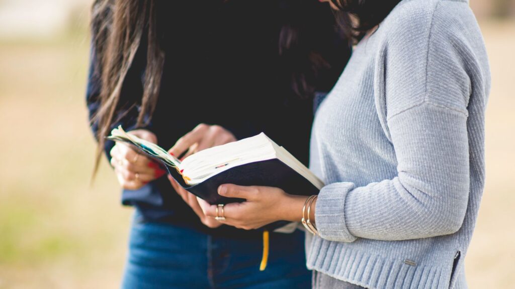 young women reading the bible together