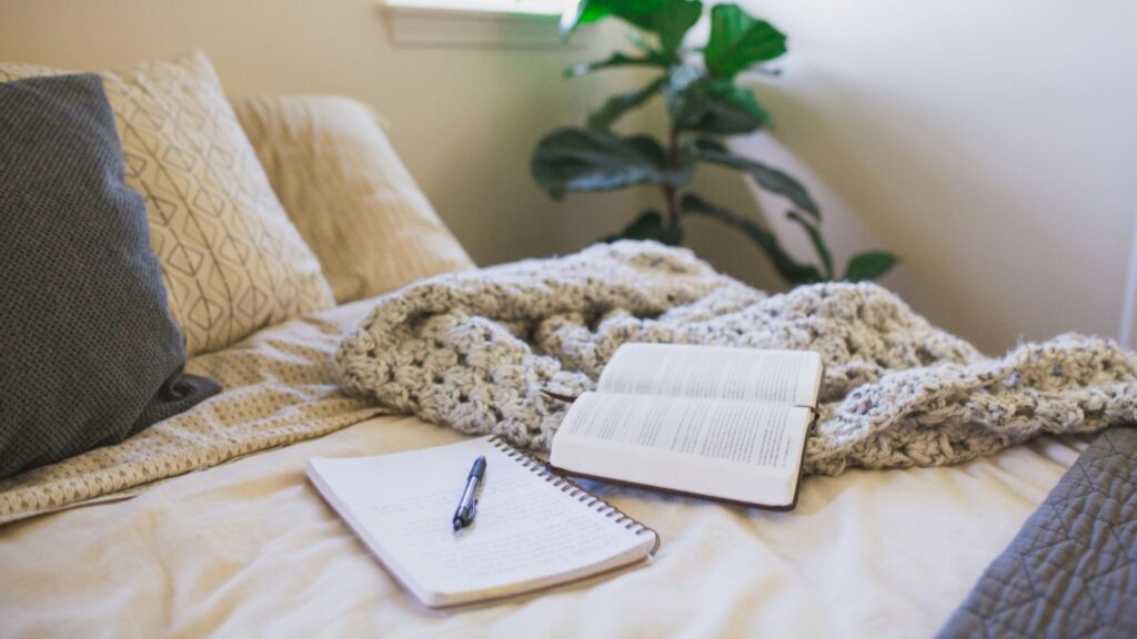 Bible reading and journaling in a minimalist bedroom
