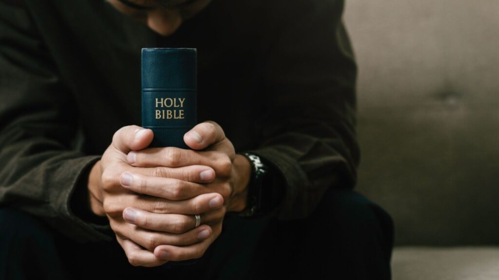 Christian pray and worship god with belief and spirituality. Hand praying and praise with the holy bible in church. young man prayer confession sin for seeking