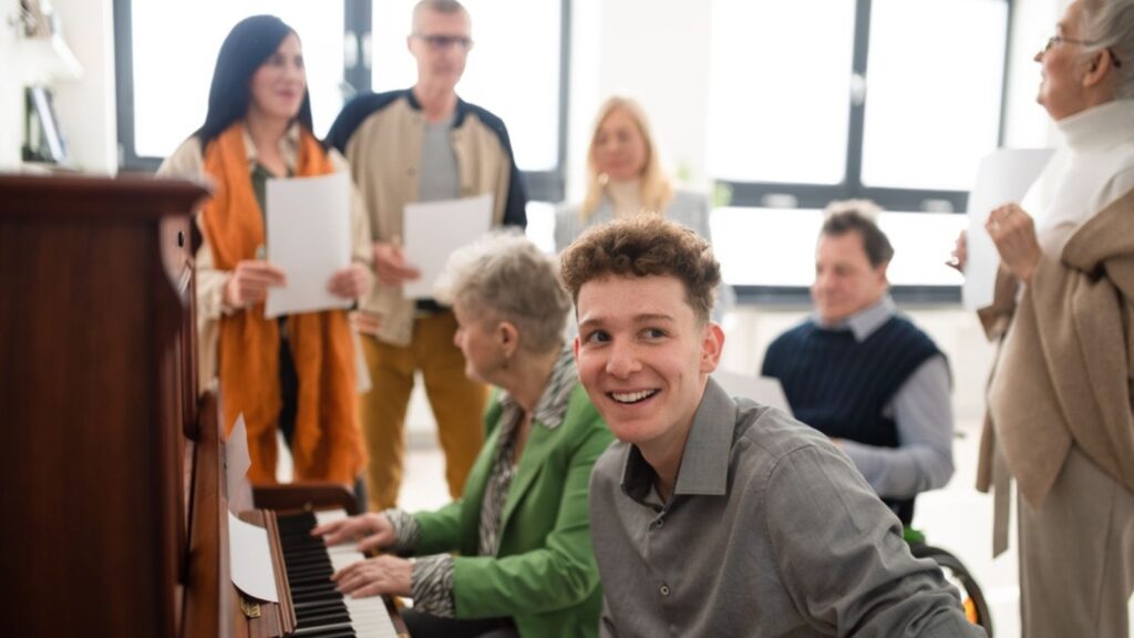 Group of choir with young teacher singing together at choir rehearsal