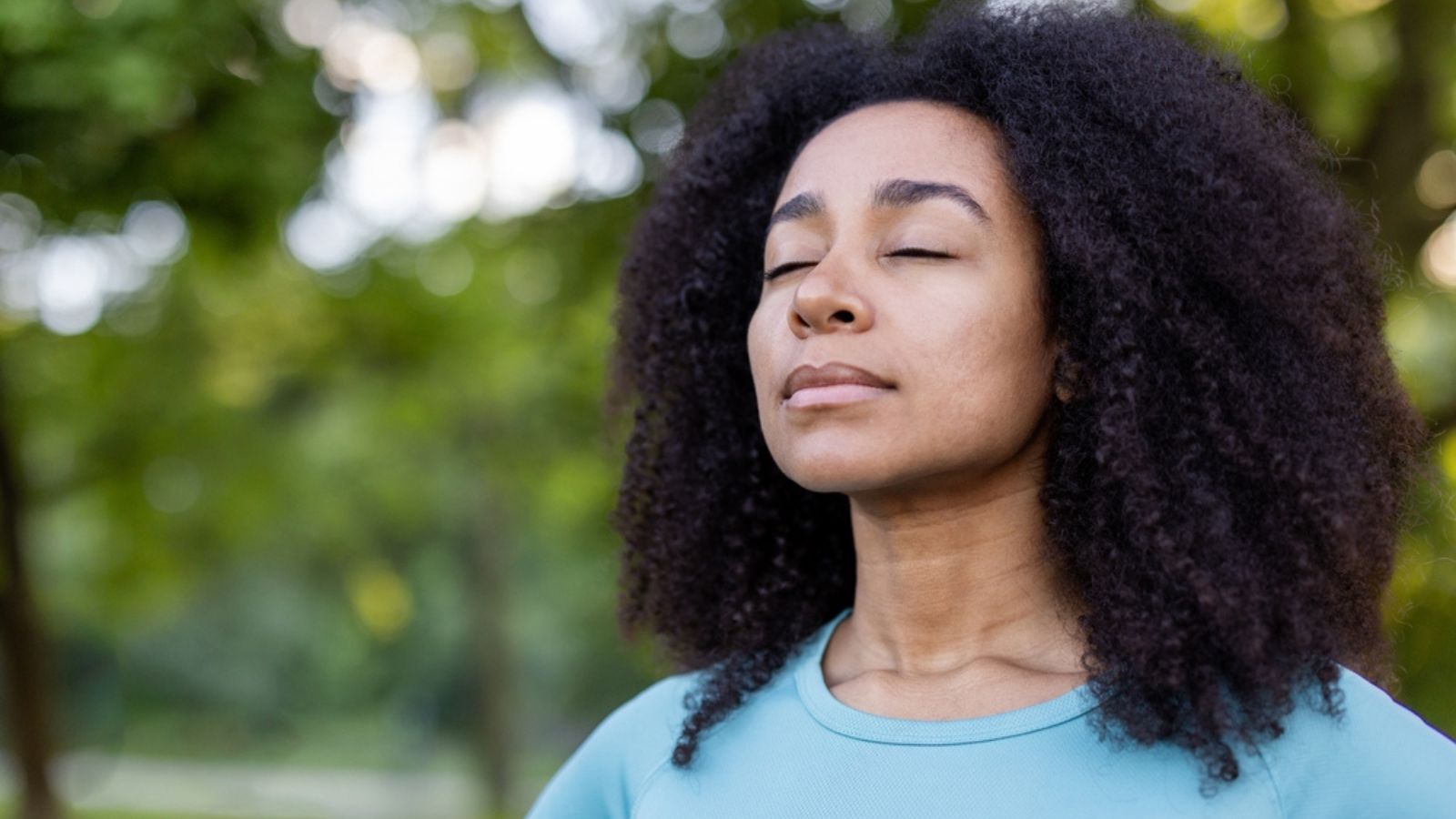 Woman embracing mindfulness in tranquil outdoor environment, eyes closed in peaceful meditation. Connection with nature promotes relaxation and inner peace,mental wellness