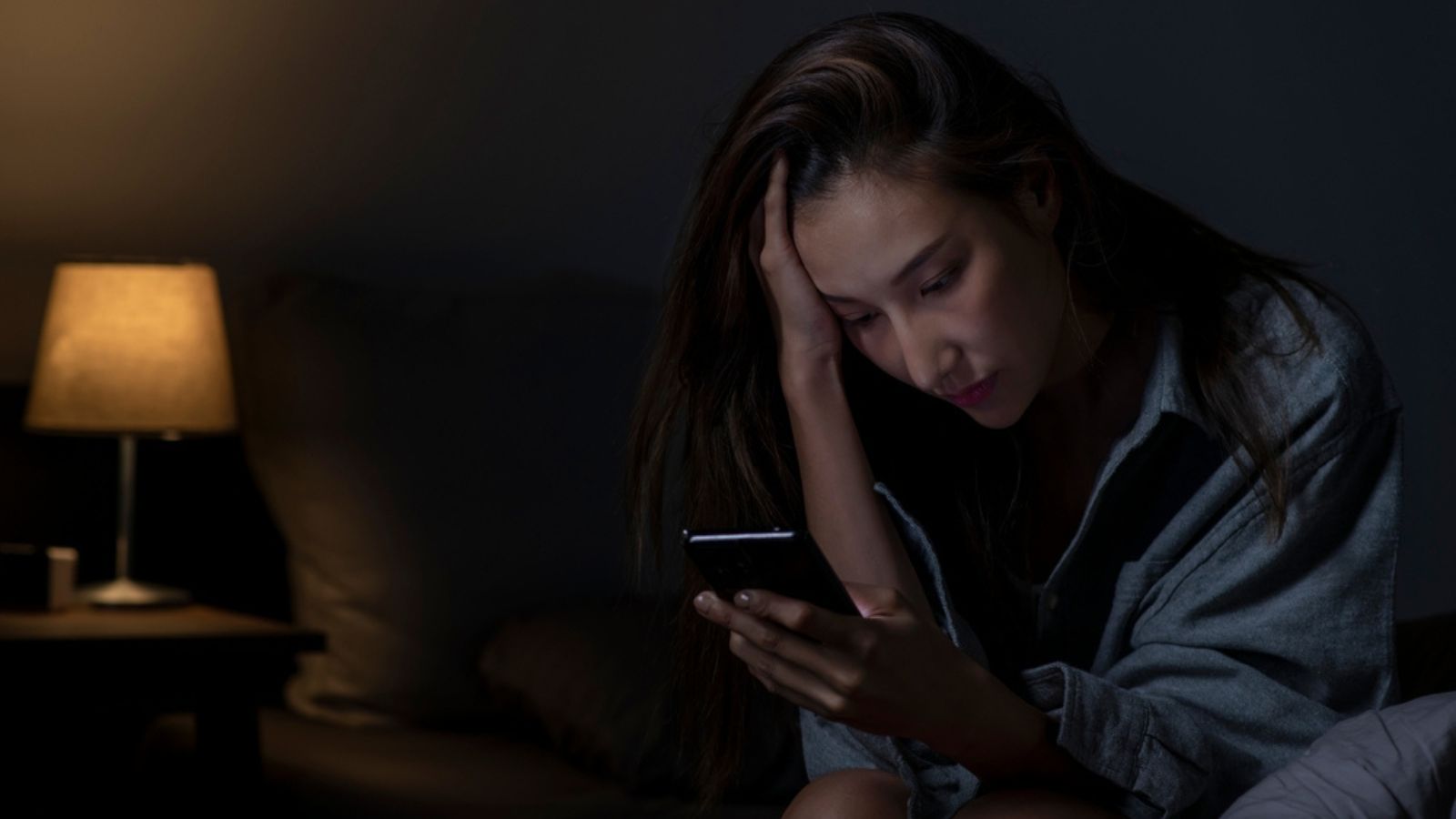 woman using smartphone in bed cannot sleep from insomnia, depressed woman in bedroom,comparison