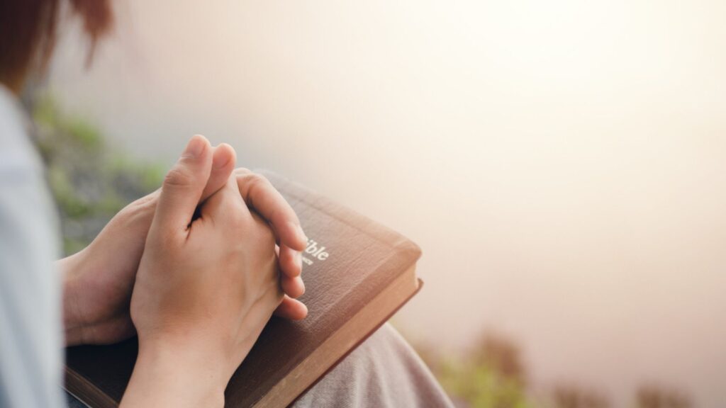 girl's hand sitting praying for god's blessing Along with coming to heal a peaceful life with nature. and the Holy Word