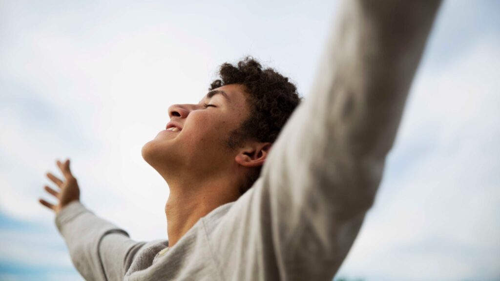 teen boy worshipping ,praising,man