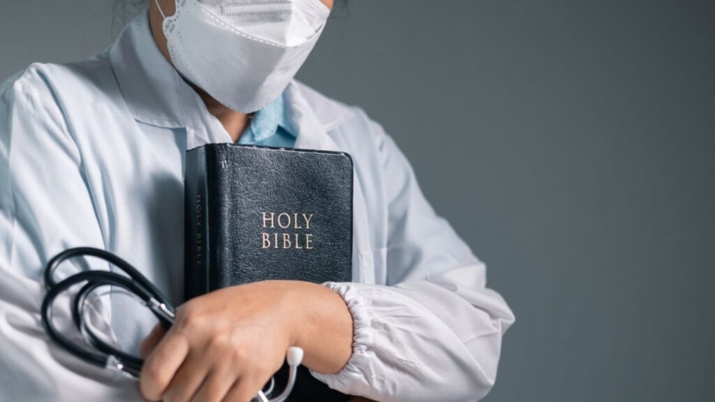 Doctor clasped their hands in prayer, hoping for the best as they provided medical care in hospital clinic. doctor, pray, medicine, health, medical, hand, hospital,faith and science
