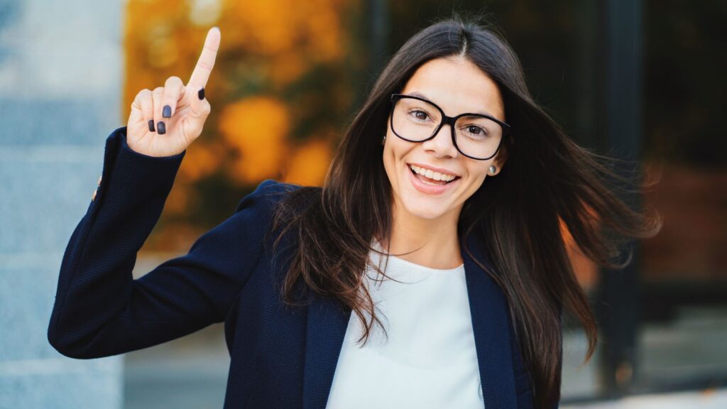 Smiling Happy Student Girl Showing Eureka Gesture. Portrait Of Young Thinking