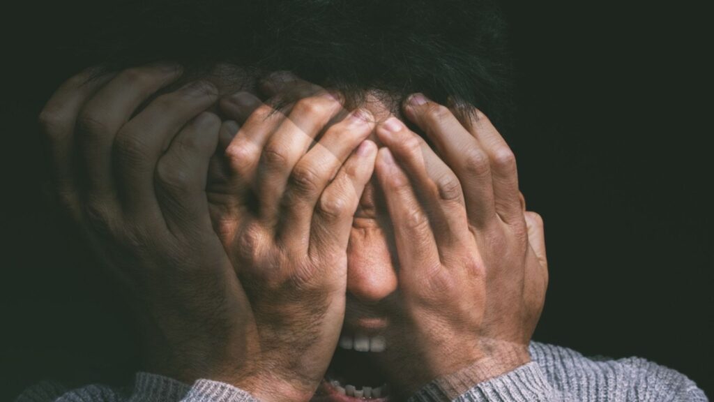 When your mind is your own worst enemy. Studio shot of a young man experiencing mental anguish and screaming against a black background