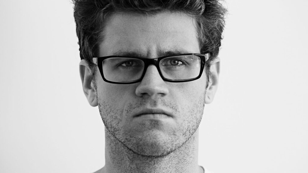 angry man in glasses staring,skeptical