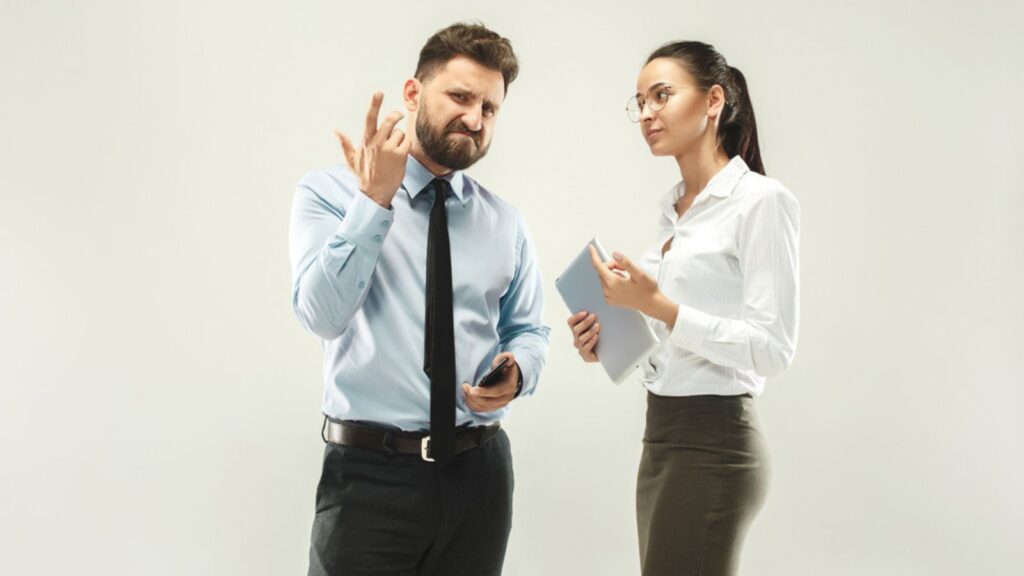 Angry boss. Man and his secretary standing at office or studio.office relationship concept