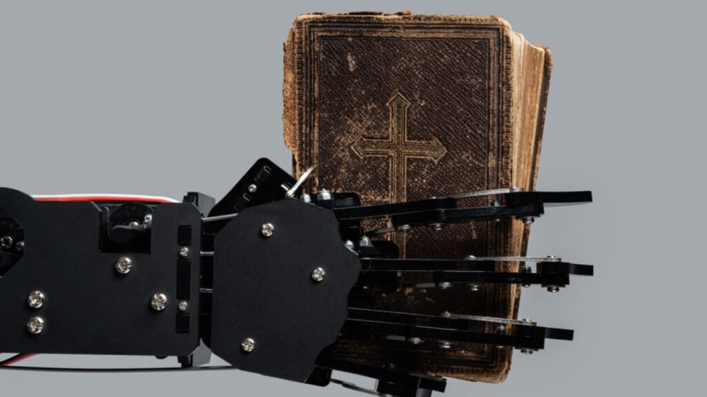 Real robot's hand with ancient Bible book. Concepts of artificial intelligence development and machine learning.