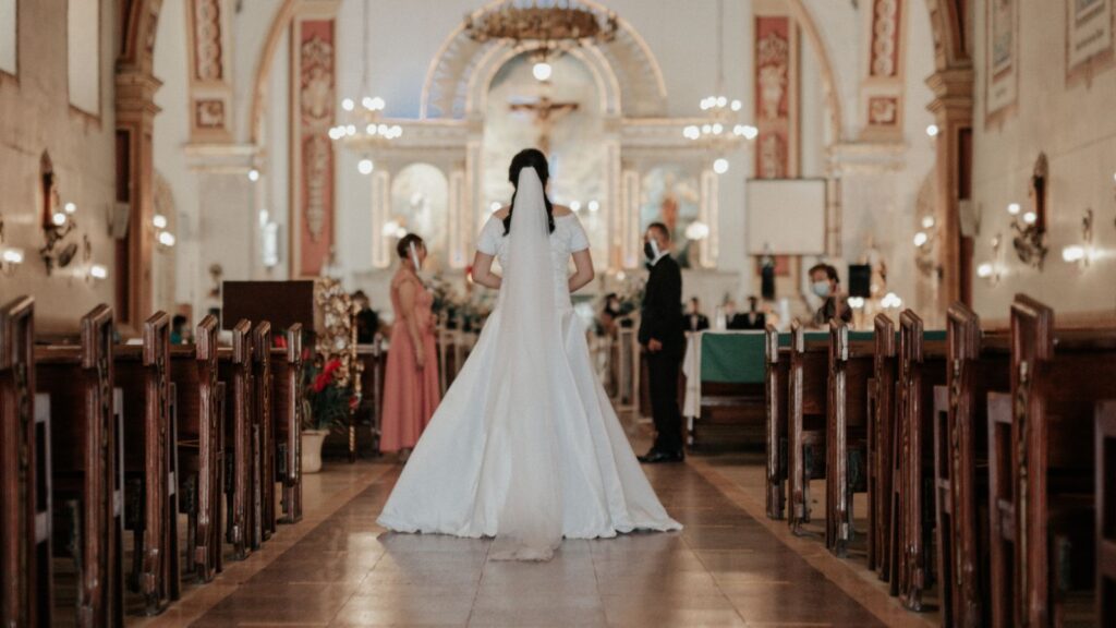 a bride walking down a aisle in a church wedding